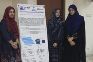Students at IEEE SZABIST Hyderabad Student Branch Innofest 17 with their poster