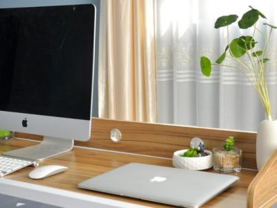 Picture of desk with computer and laptop