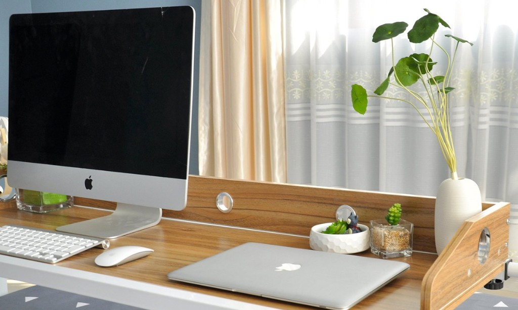 Picture of desk with computer and laptop